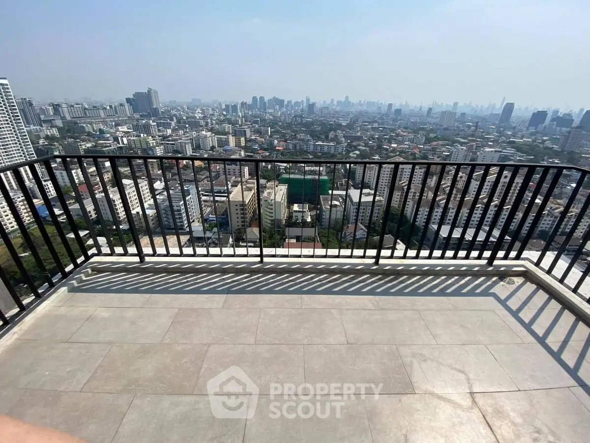 Stunning cityscape view from a spacious balcony in a high-rise building.