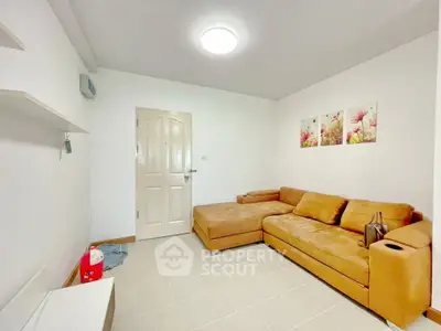 Cozy living room with modern decor and comfortable seating in a stylish apartment.