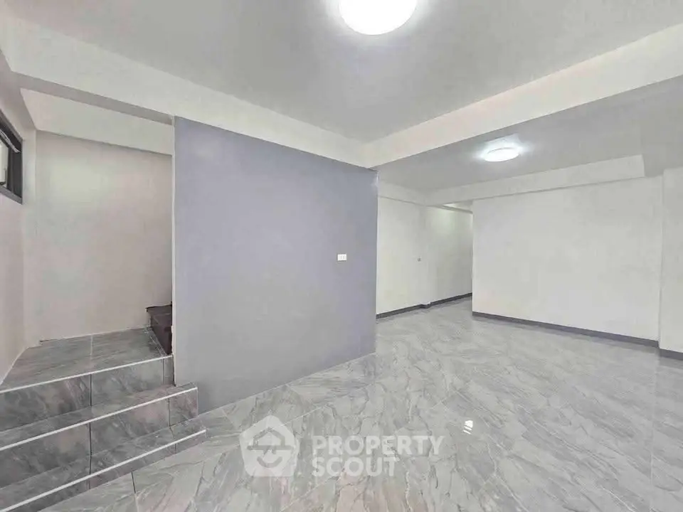 Spacious modern interior with sleek marble flooring and neutral walls, perfect for customization.