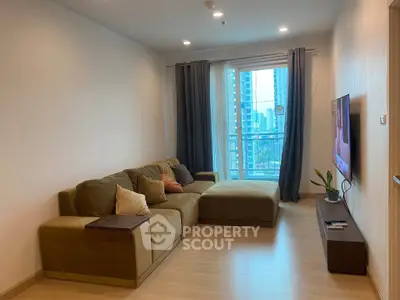 Modern living room with cozy sectional sofa and city view balcony