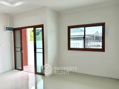 Bright interior with large windows and sliding glass door leading to a patio, perfect for natural light lovers.