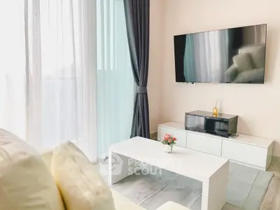 Modern living room with sleek TV, white furniture, and elegant curtains.
