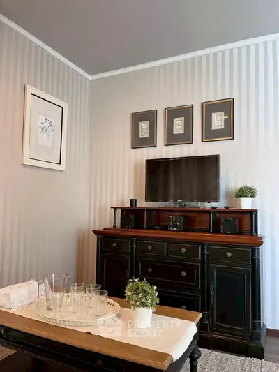 Charming living room with elegant furniture and wall art, perfect for cozy relaxation.