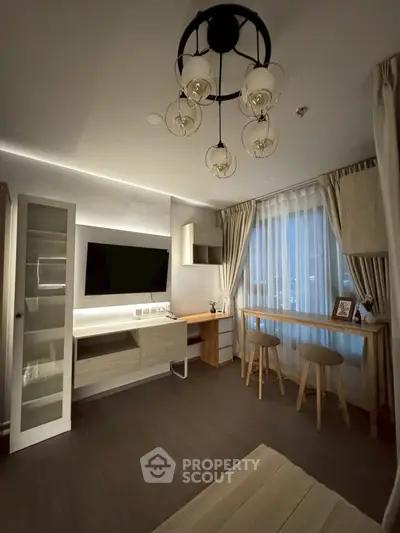 Modern living room with stylish lighting and cozy seating area, perfect for relaxation and entertainment.