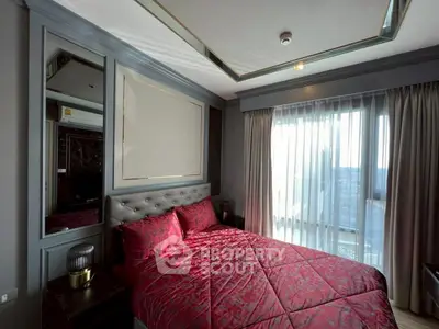 Luxurious bedroom with elegant decor and large window offering natural light.