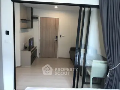 Modern apartment interior with sliding glass doors and cozy living area