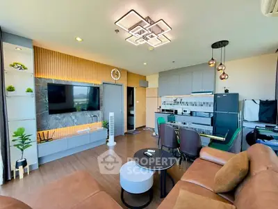 Modern living room with stylish decor, open kitchen, and elegant lighting in a contemporary apartment.