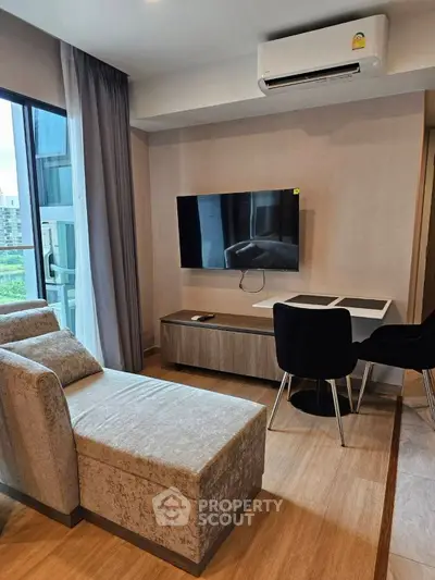 Modern living room with stylish furniture and wall-mounted TV, featuring a cozy ambiance.