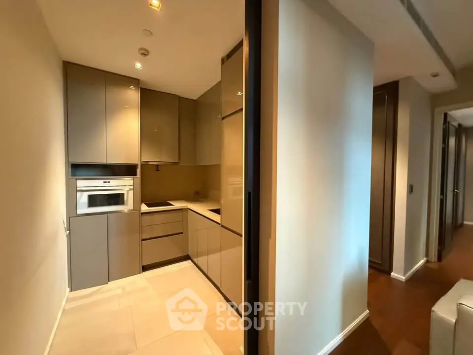 Modern kitchen with sleek cabinetry and built-in appliances in a stylish apartment.