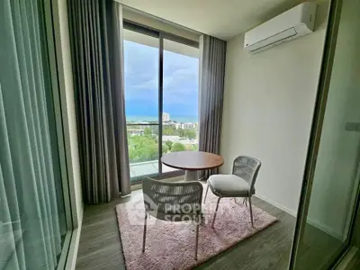 Charming small balcony with ocean view, featuring cozy seating and modern air conditioning.