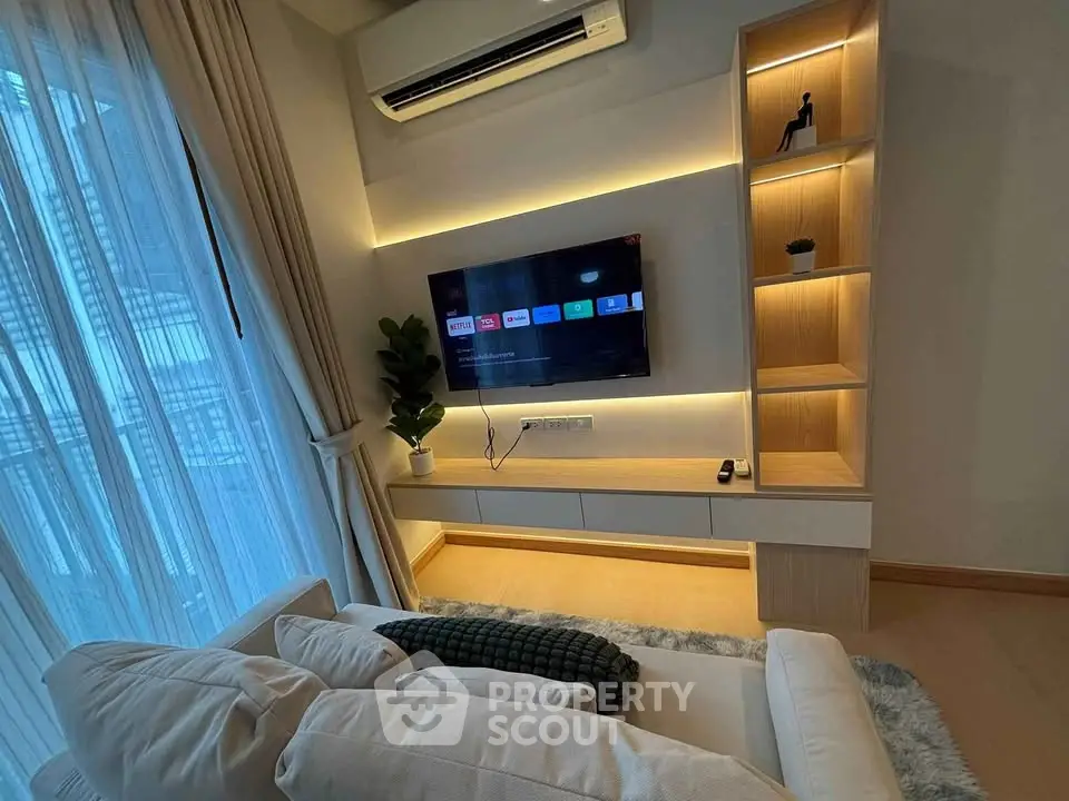 Modern living room with sleek TV setup and ambient lighting
