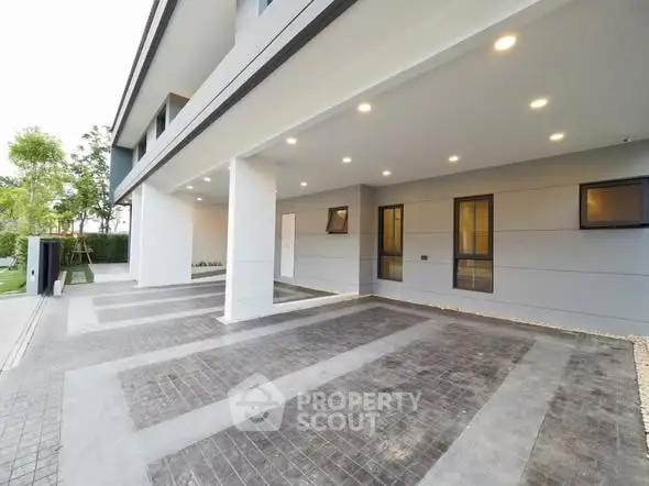 Spacious modern building entrance with ample parking area and sleek design.