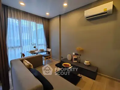 Modern living room with cozy sofa, dining area, and air conditioning.