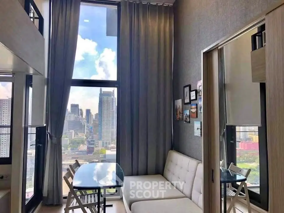 Modern living room with city view, featuring high ceilings and stylish decor in a luxury apartment.