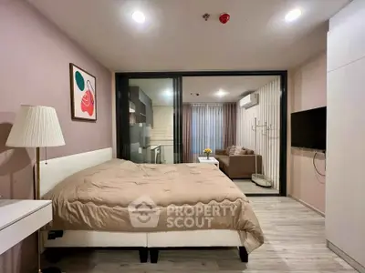 Modern studio apartment with cozy bedroom and stylish living area, featuring sleek design and ample natural light.