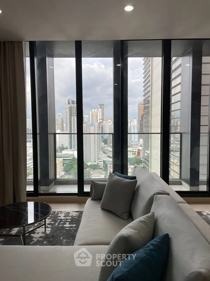 Luxurious living room with stunning city view from floor-to-ceiling windows.