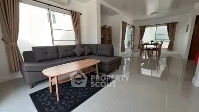 Spacious living room with modern furniture and large windows for natural light.