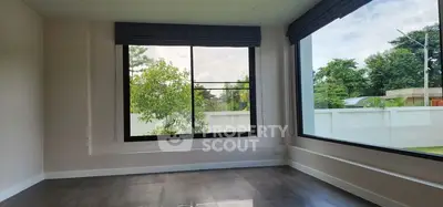 Spacious room with large windows and garden view, perfect for natural light lovers.