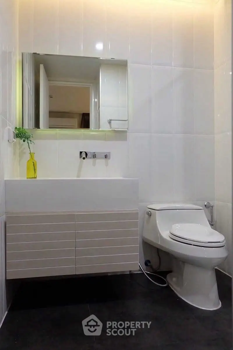 Modern bathroom with sleek white fixtures and minimalist design