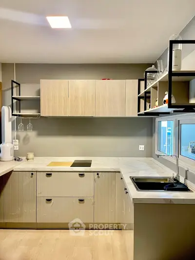 Modern kitchen with sleek cabinetry and open shelving in a contemporary home.