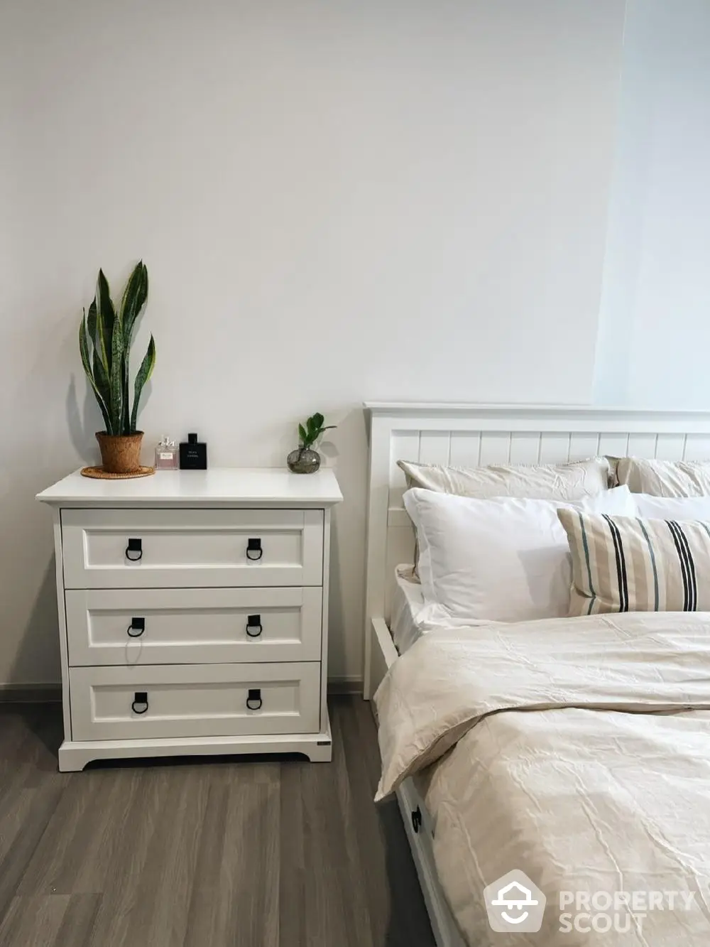 Elegant bedroom with white furniture and cozy bedding