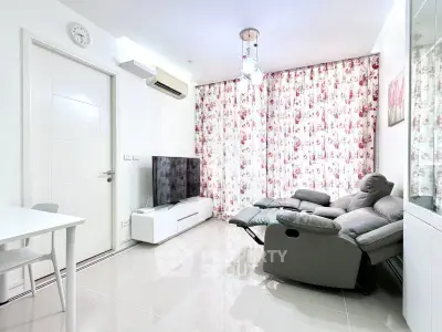 Modern living room with floral curtains, sleek furniture, and a wall-mounted TV for a cozy ambiance.