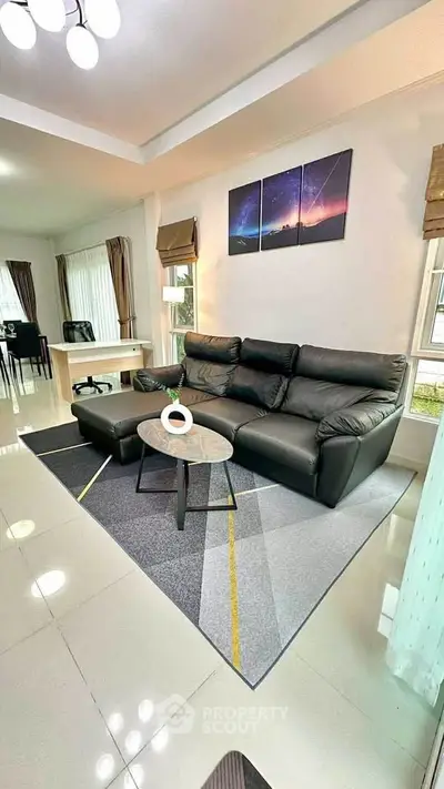 Modern living room with sleek black leather sofa and stylish decor