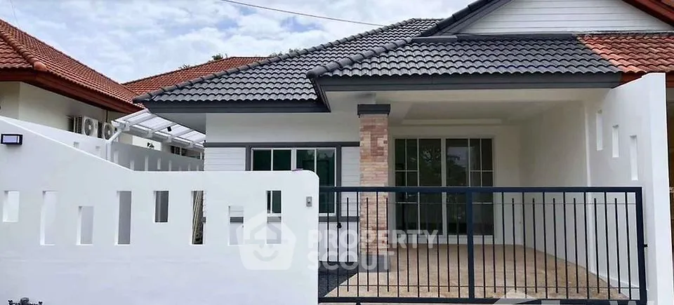 Charming single-story house with tiled roof and spacious front patio