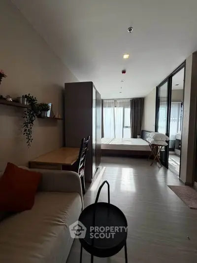 Modern studio apartment with cozy living area and natural light