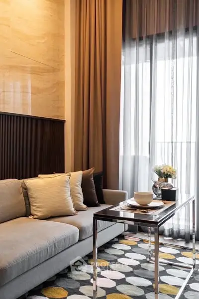 Stylish living room with modern decor and large window, perfect for relaxation.