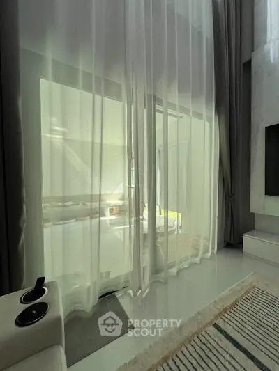 Luxurious modern living room with sheer curtains and elegant decor