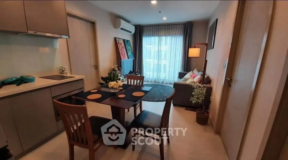 Modern open-plan living room and kitchen with stylish decor and natural light.