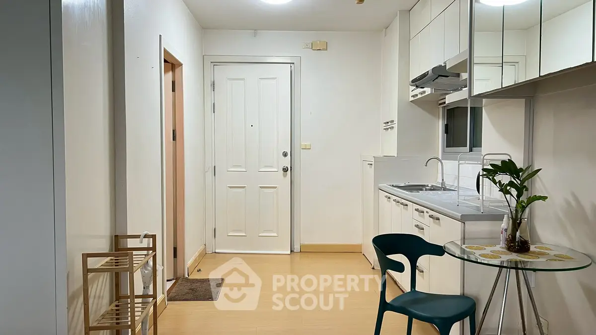 Charming apartment entrance with modern kitchen and cozy dining area