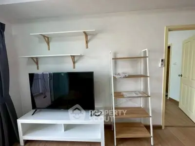 Modern living room with TV, shelves, and stylish decor