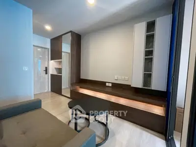 Modern living room with sleek furniture and built-in storage in a stylish apartment.