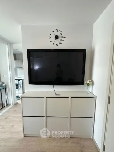 Modern living room with wall-mounted TV and stylish storage unit