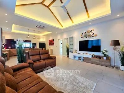 Luxurious modern living room with high ceilings, elegant lighting, and stylish decor