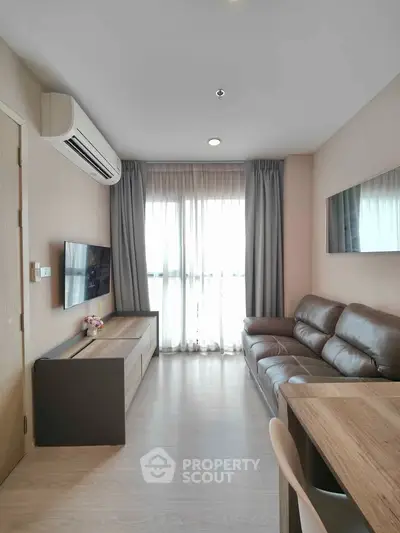 Modern living room with leather sofa and natural light in stylish apartment.