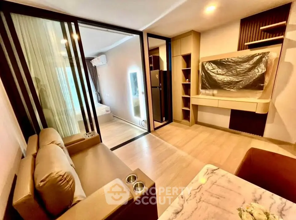 Modern living room with sliding glass doors and stylish furniture in a contemporary apartment.
