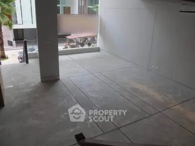 Spacious modern interior with large windows and concrete flooring