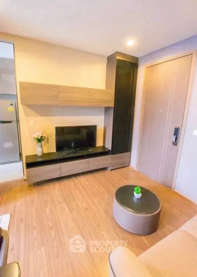 Modern living room with sleek wooden flooring and stylish TV unit