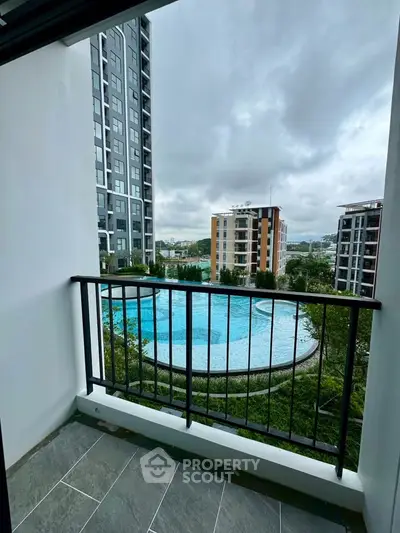 Modern balcony with pool view in urban apartment complex
