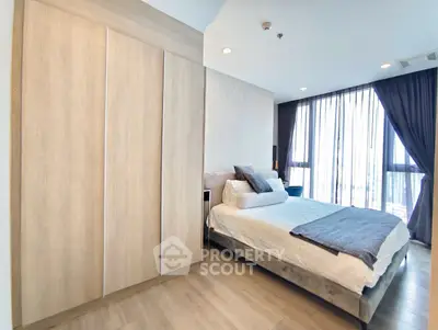 Spacious modern bedroom with large windows and stylish decor