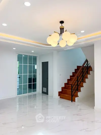 Spacious modern living room with elegant staircase and stylish lighting
