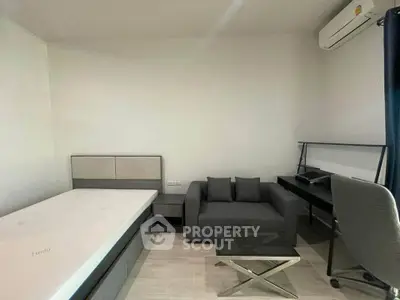 Modern minimalist bedroom with sleek furniture and air conditioning