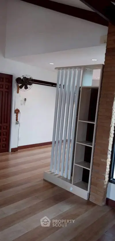 Spacious living room with wooden flooring and modern partition design