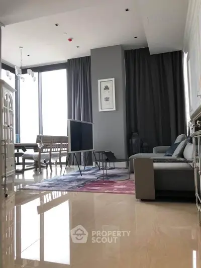Spacious modern living room with elegant decor and large windows for natural light.