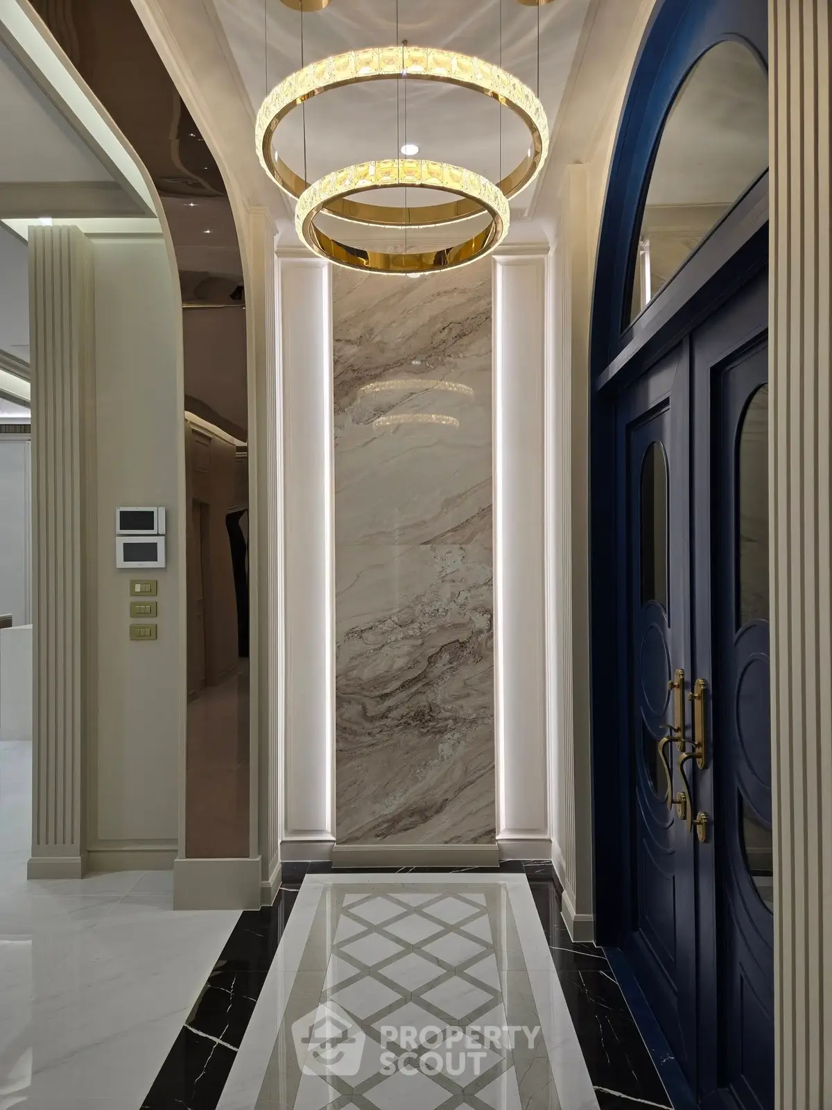 Luxurious entrance with elegant lighting and marble accents