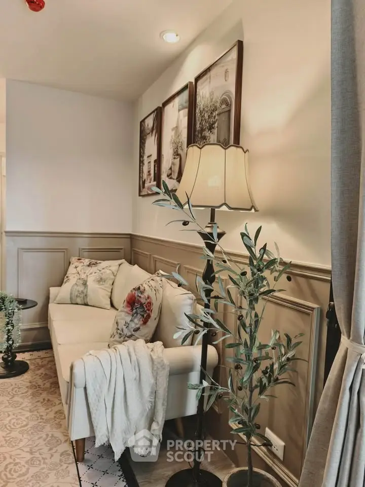 Charming living room with elegant decor, cozy sofa, and stylish floor lamp, perfect for relaxation and entertaining.