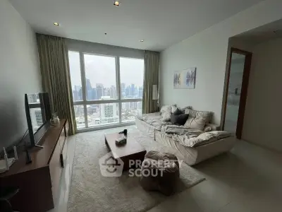 Modern living room with panoramic city view, cozy seating, and stylish decor in a high-rise apartment.
